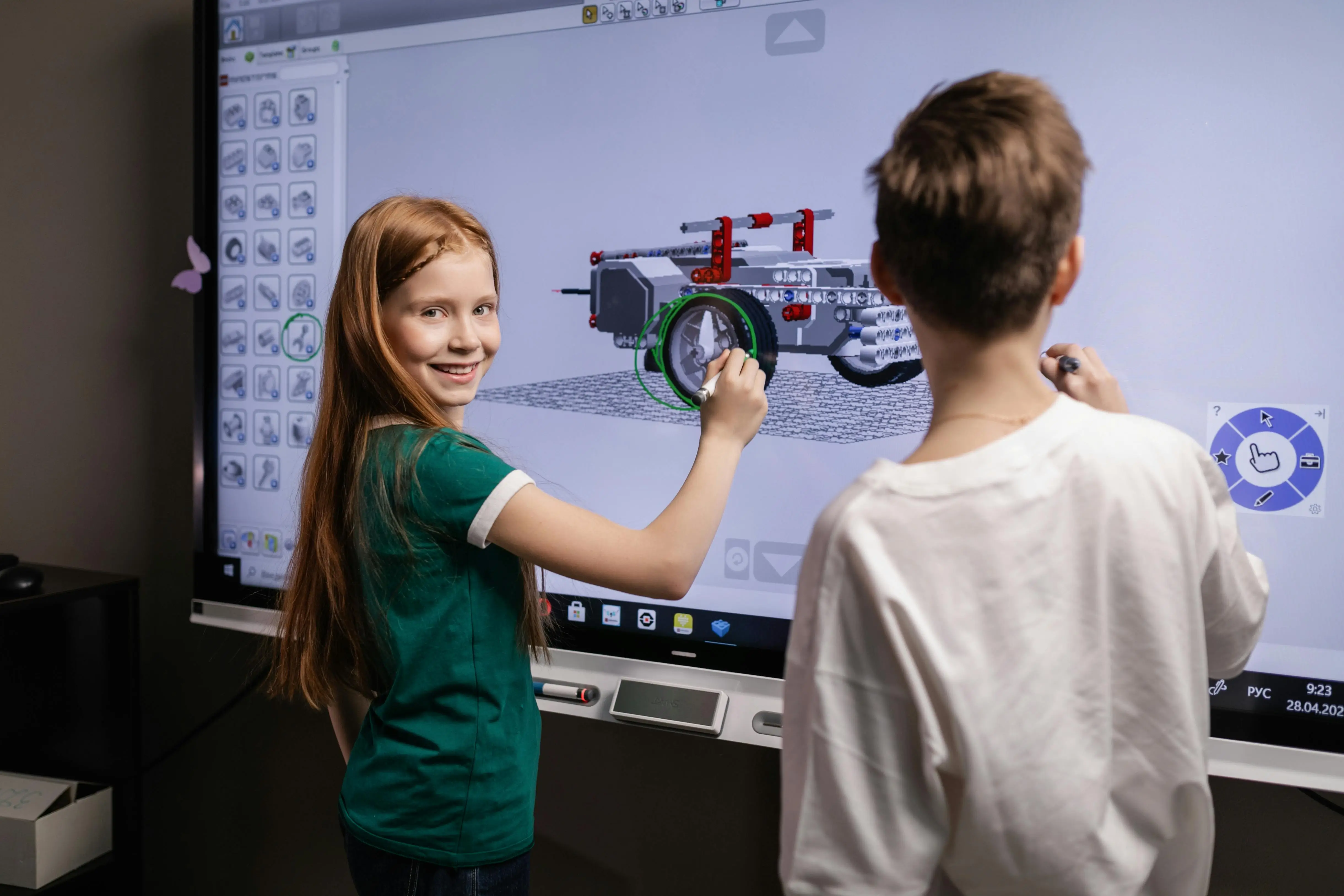 Two students planning an engineering project on a projector